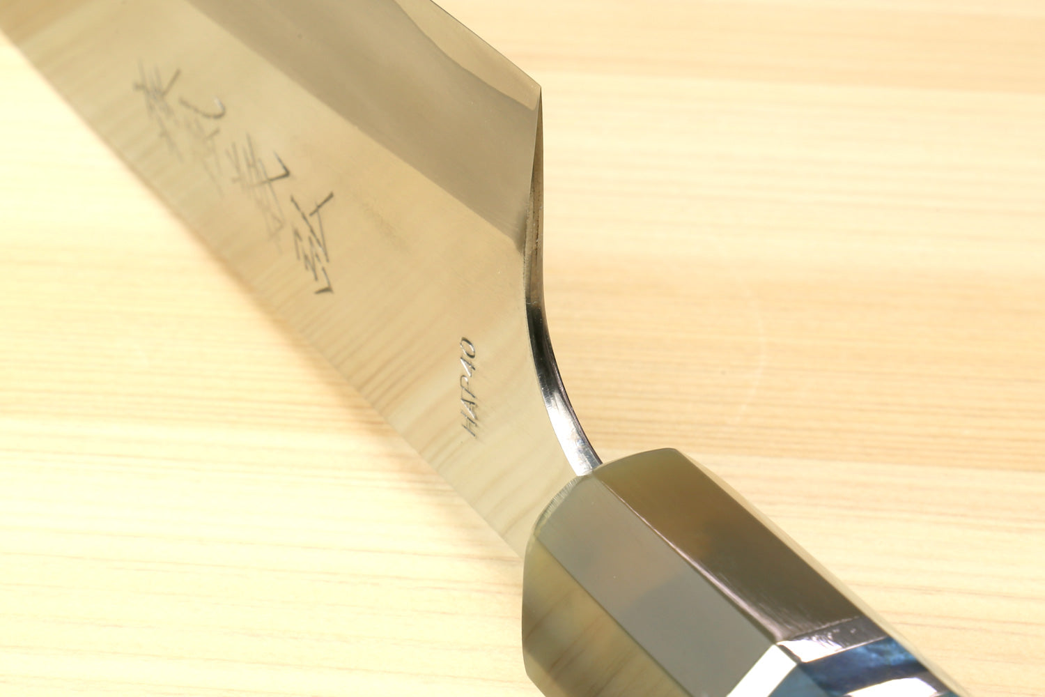 Gyuto chef's knife with blue patterned handle and curved blade heel