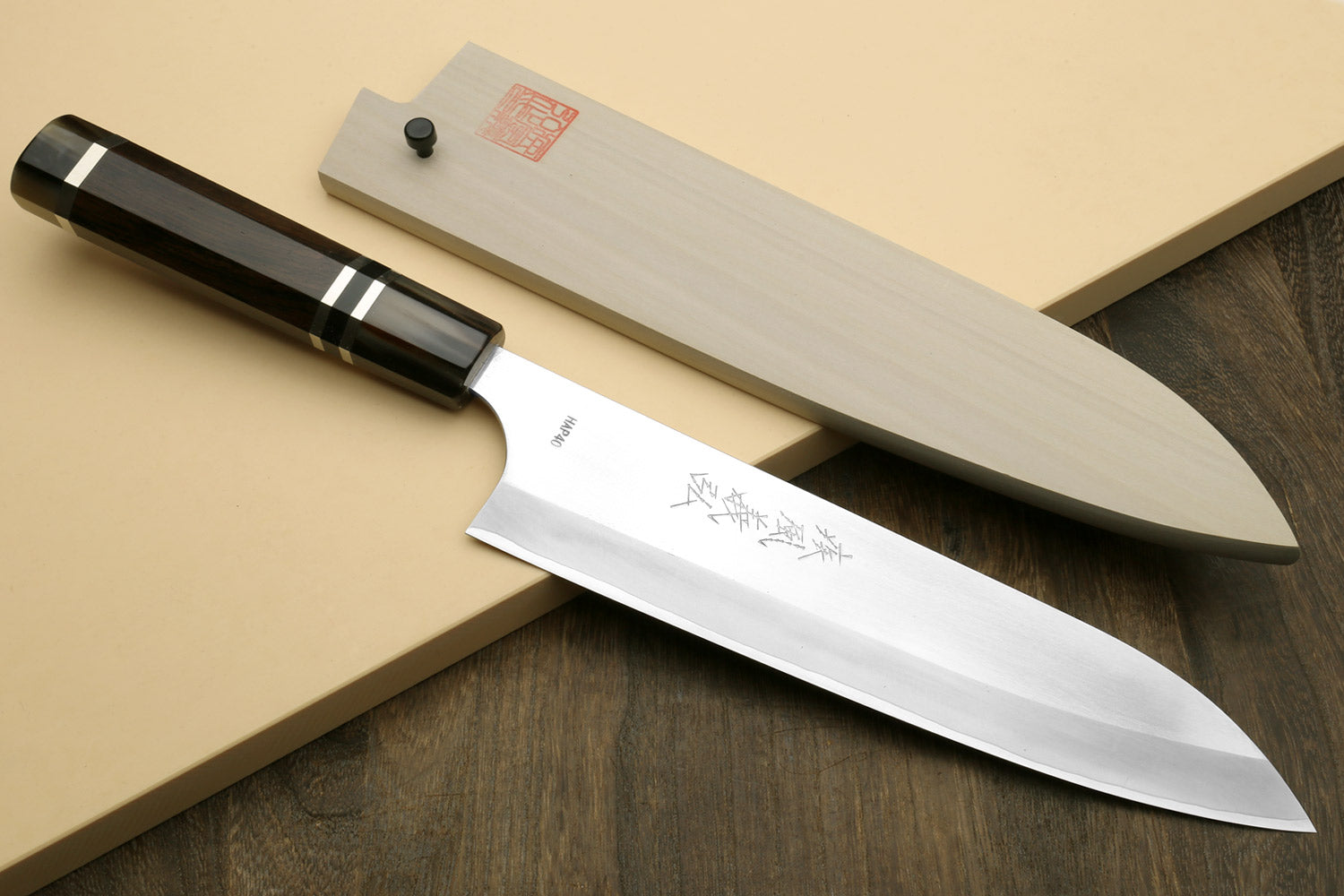 Chef knife with dark ebony triple-ring handle and white saya cover
