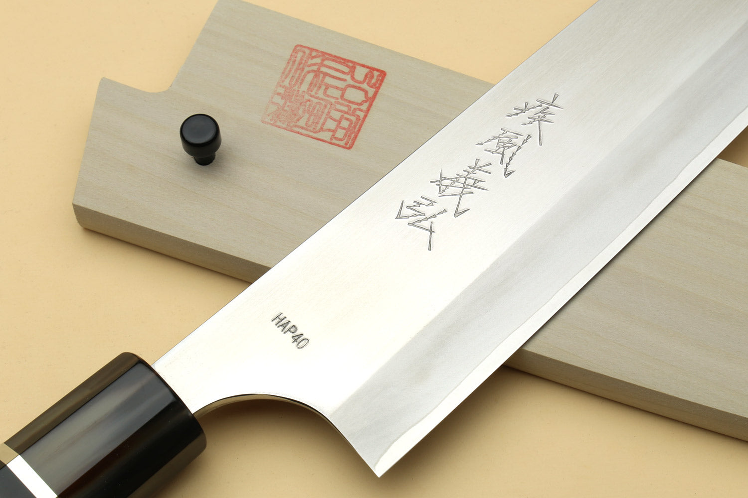 Chef knife blade with engraved pattern and white saya cover