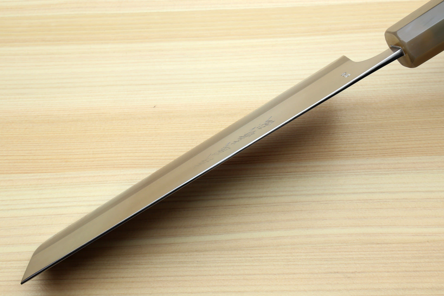 Nakiri knife blade with stamped logo on the side, steel finish, dark patterned handle