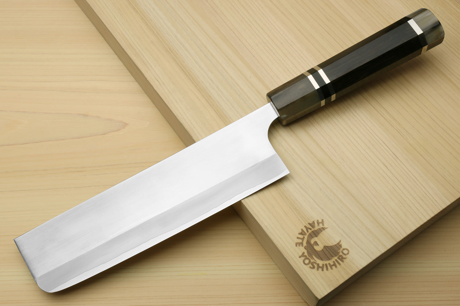 Nakiri vegetable chef knife with white blade and dark octagonal ebony handle, triple ring accents