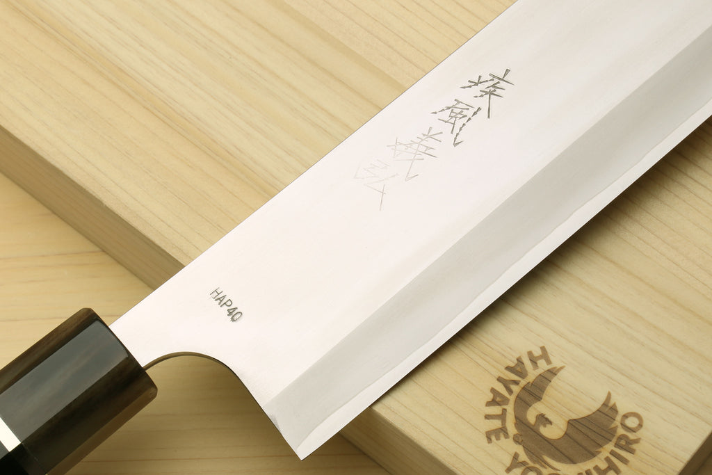Nakiri vegetable chef knife blade with stamped markings and wooden handle end