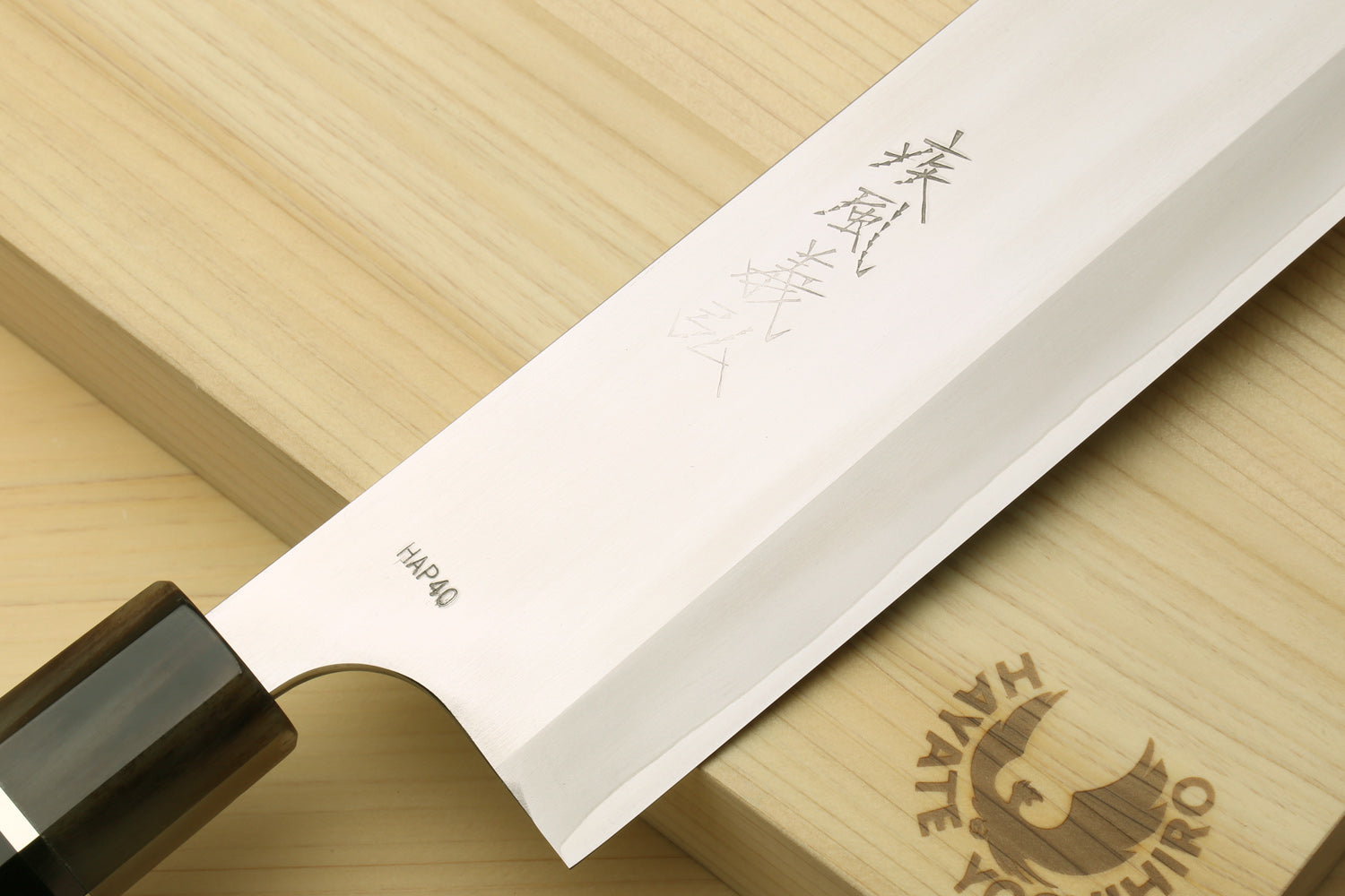 Nakiri vegetable chef knife blade with stamped markings and wooden handle end