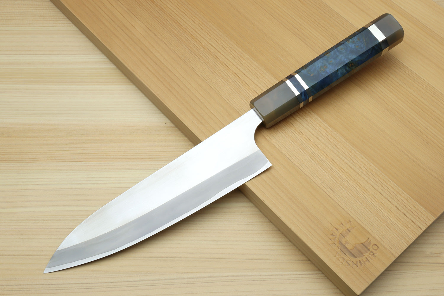 HAP40 petty chef knife with ocean blue handle and white blade on wooden board