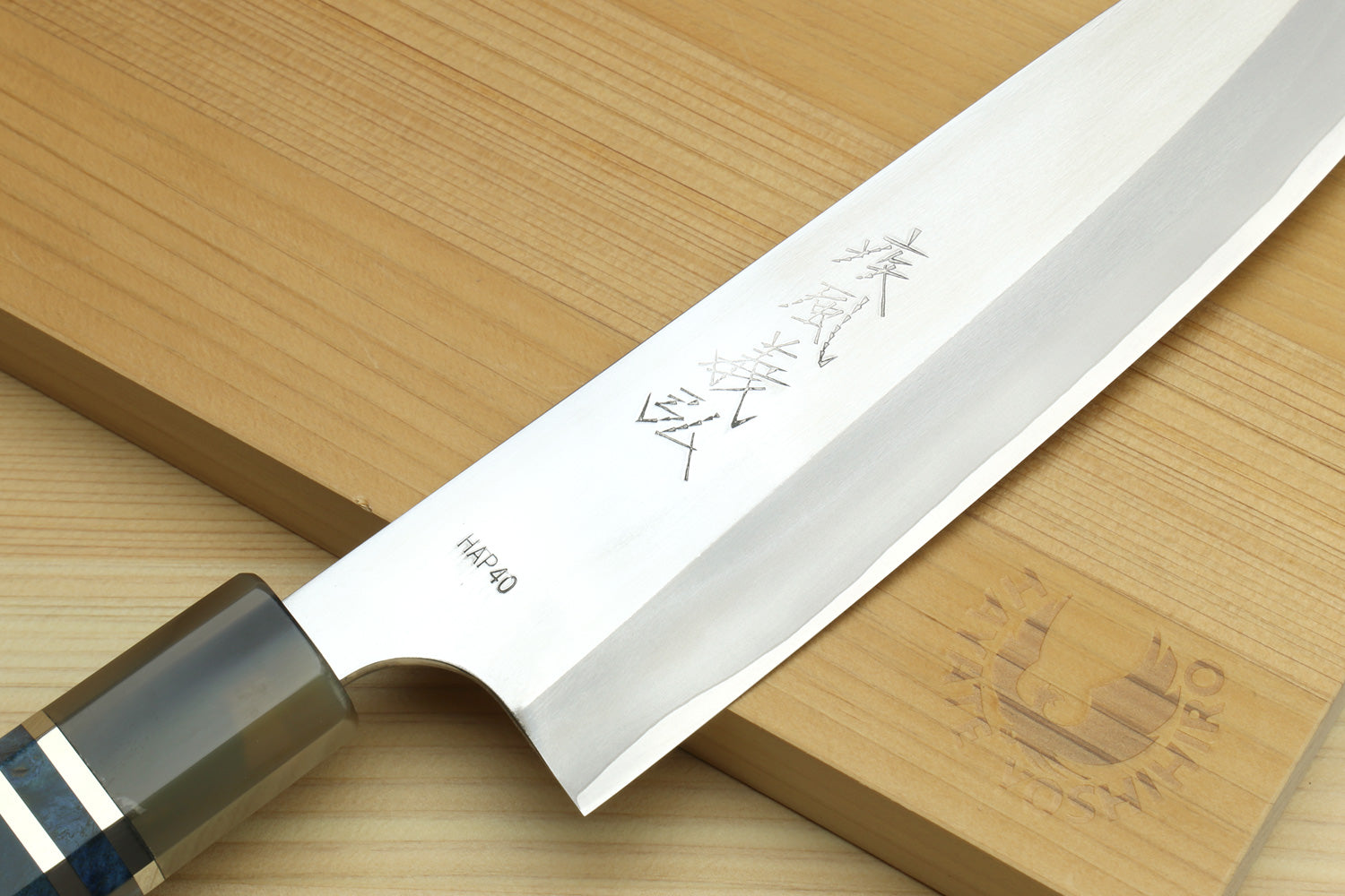Close-up of HAP40 petty chef knife blade with engraved markings