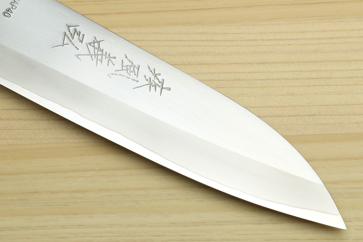 Petty chef knife blade tip close-up with stamped pattern