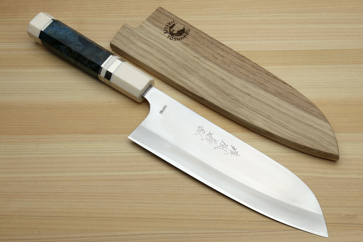 Santoku chef's knife with wooden saya and silver blade with etched text