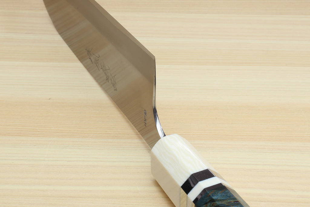Santoku chef's knife blade edge and dark blue handle with ivory bolster