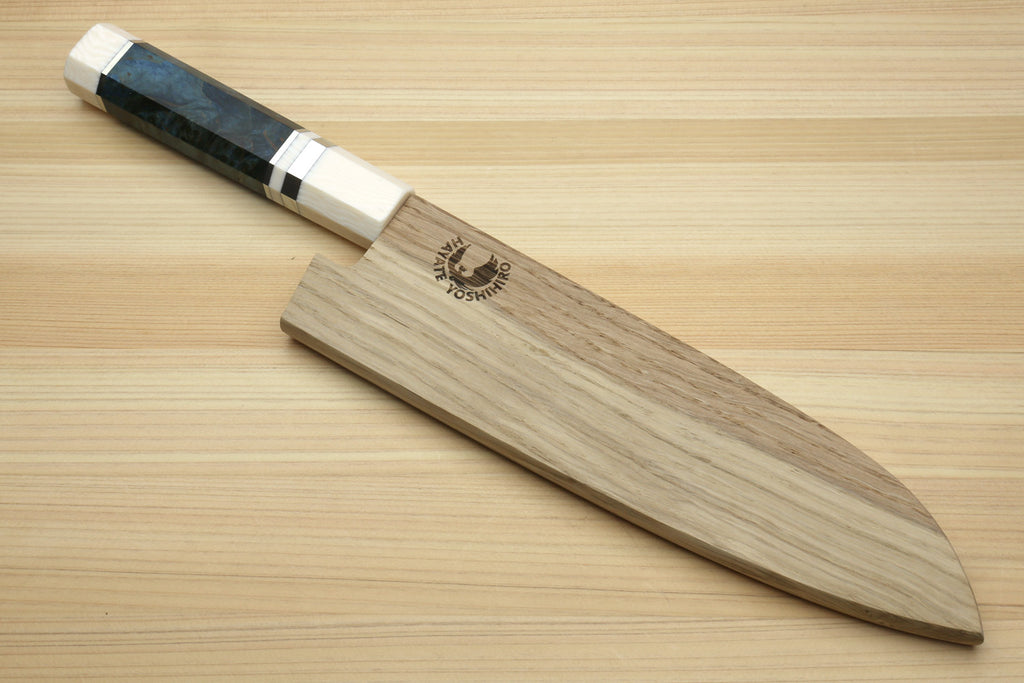 Santoku knife with dark blue handle next to wooden saya with logo