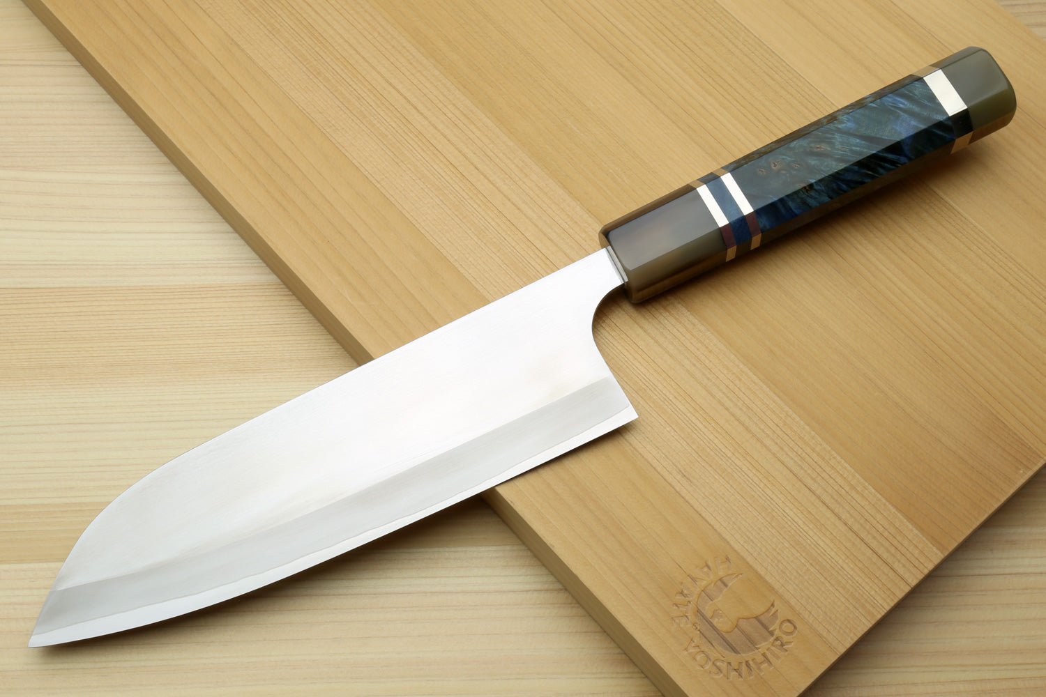 Santoku chef's knife angled view with blue ocean-pattern handle and white blade