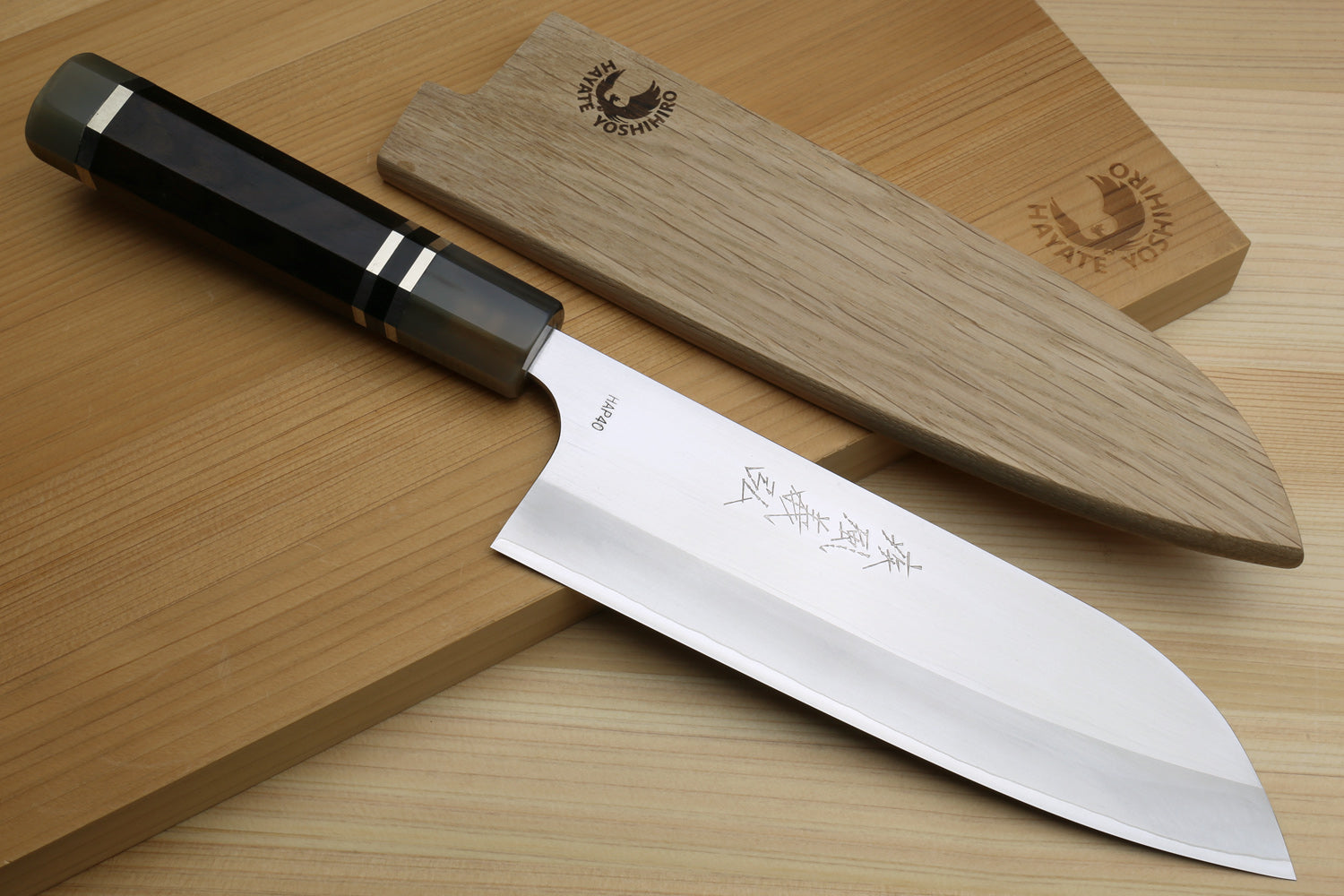 Santoku chef knife with ebony octagonal handle, HAP40 blade, and wooden saya