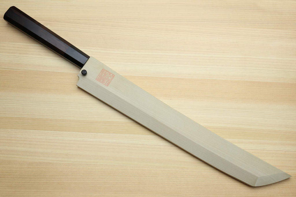 Japanese knife with dark handle and light wooden saya; mirror-finished blade shown.