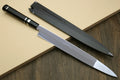 Japanese chef knife with reflective silver blade and black striped handle, side view