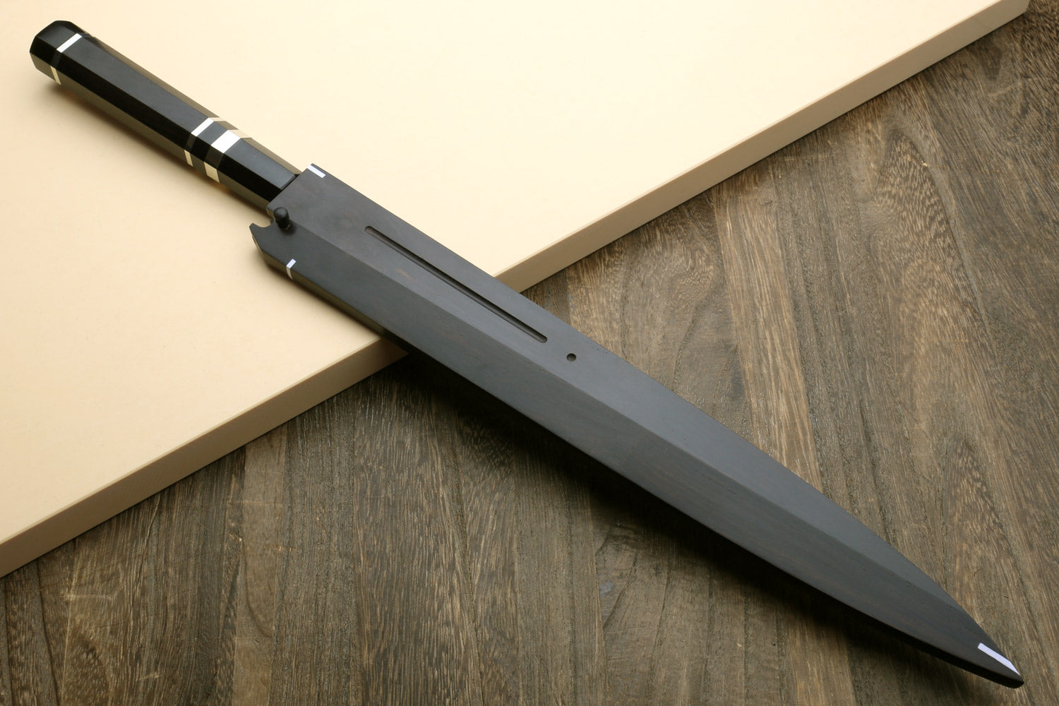 Japanese chef knife with mirror-finished silver blade and black striped handle