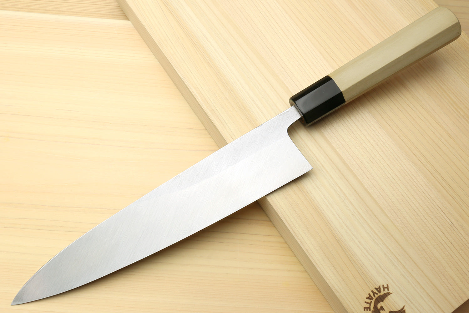 Japanese chef knife for sushi and sashimi, silver blade with black bolster and light wood handle