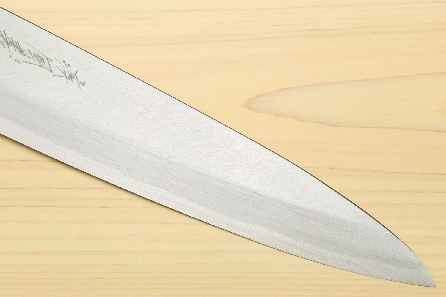 Sushi sashimi chef knife with tapered silver blade tip and fine blade texture