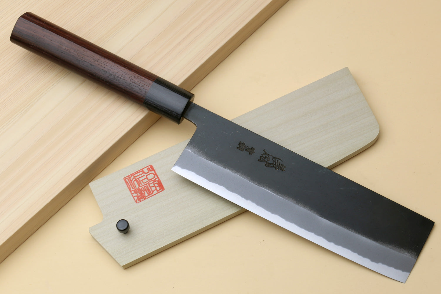 Nakiri cleaver with black blade and light wood saya cover pieces with red stamp