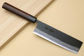 Japanese nakiri vegetable cleaver with dark wood handle and black kurouchi finish blade