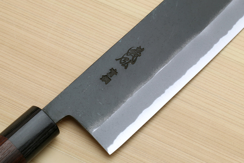 Nakiri vegetable cleaver close-up of blade with maker emblem near the handle