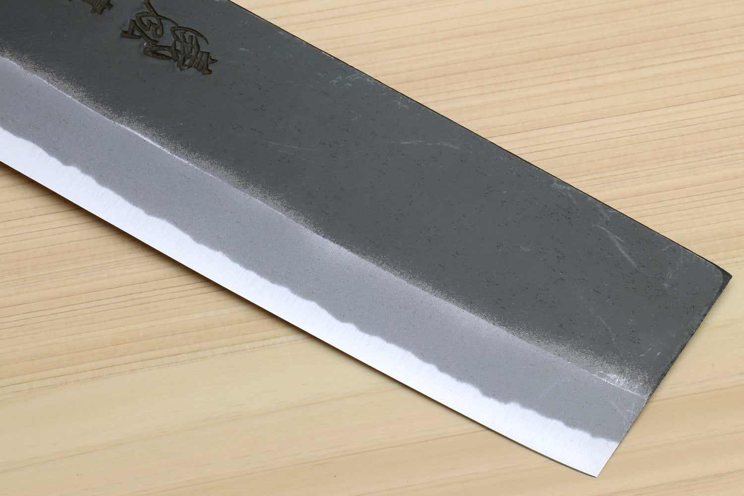 Nakiri cleaver blade close-up showing hammered texture and straight cutting edge