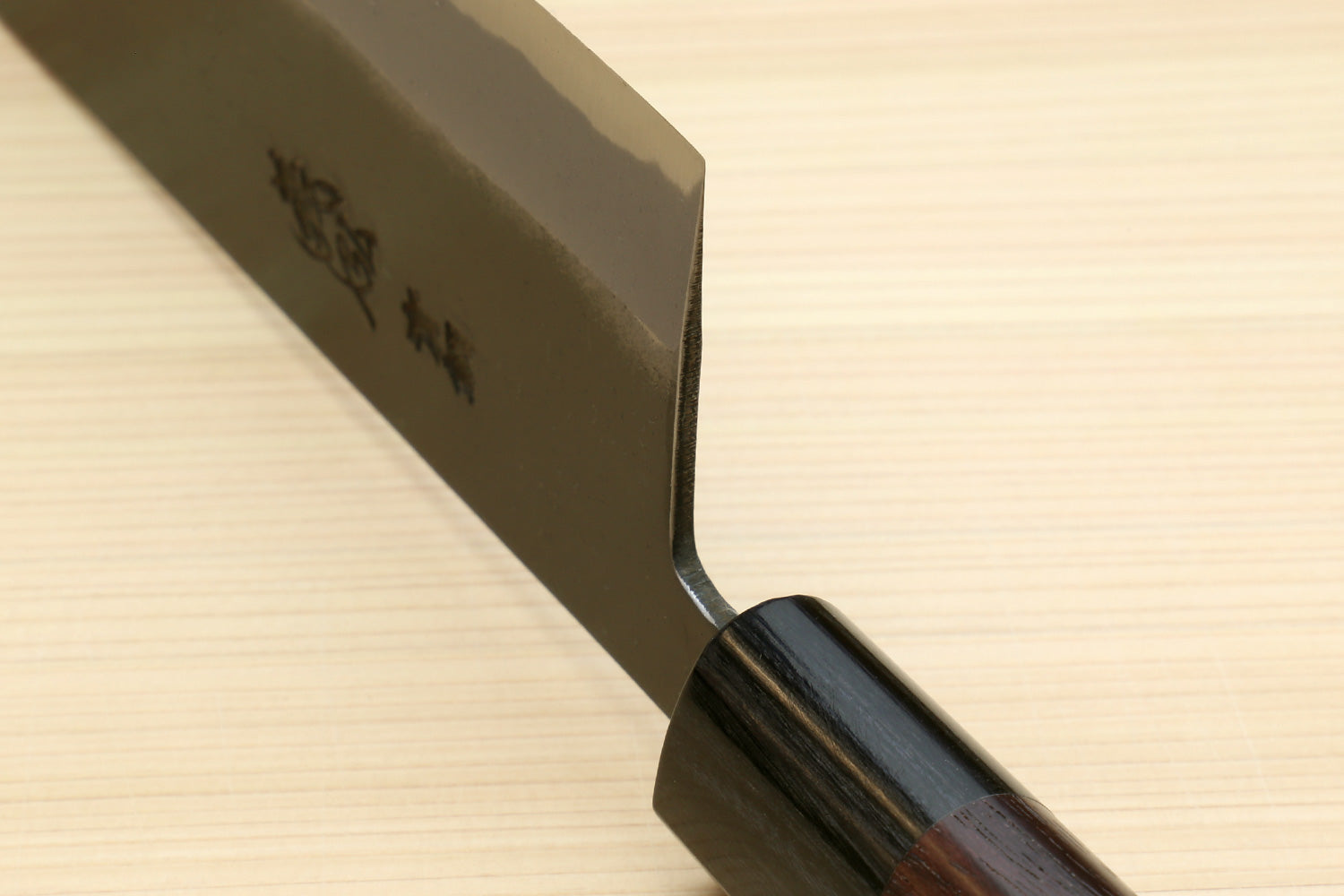 Nakiri knife tip and spine view with rounded cutting corner and dark wood handle