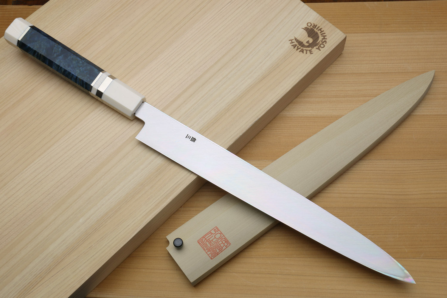 Left-handed yanagi sushi knife with mirror blade, ivory handle, and blue patterned accents