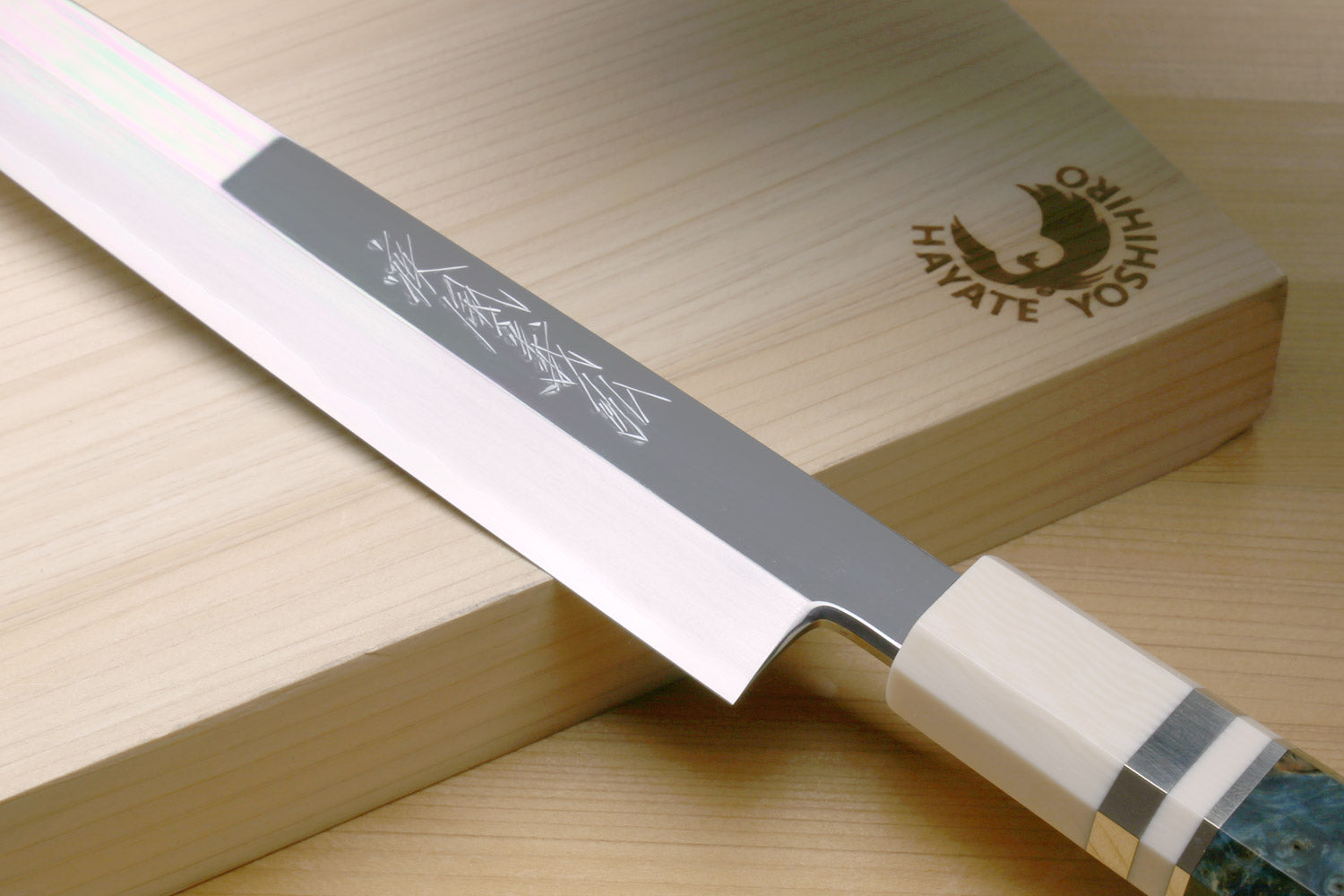 Left-handed yanagi sushi knife with mirror-polished steel blade and pale ivory handle