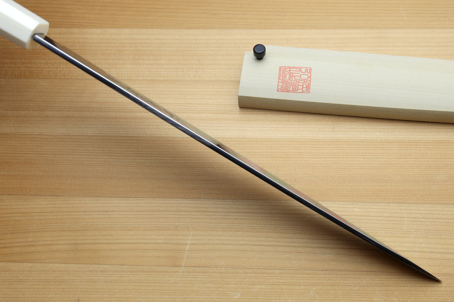 Left-handed Japanese yanagi knife with long straight blade and pale ivory handle