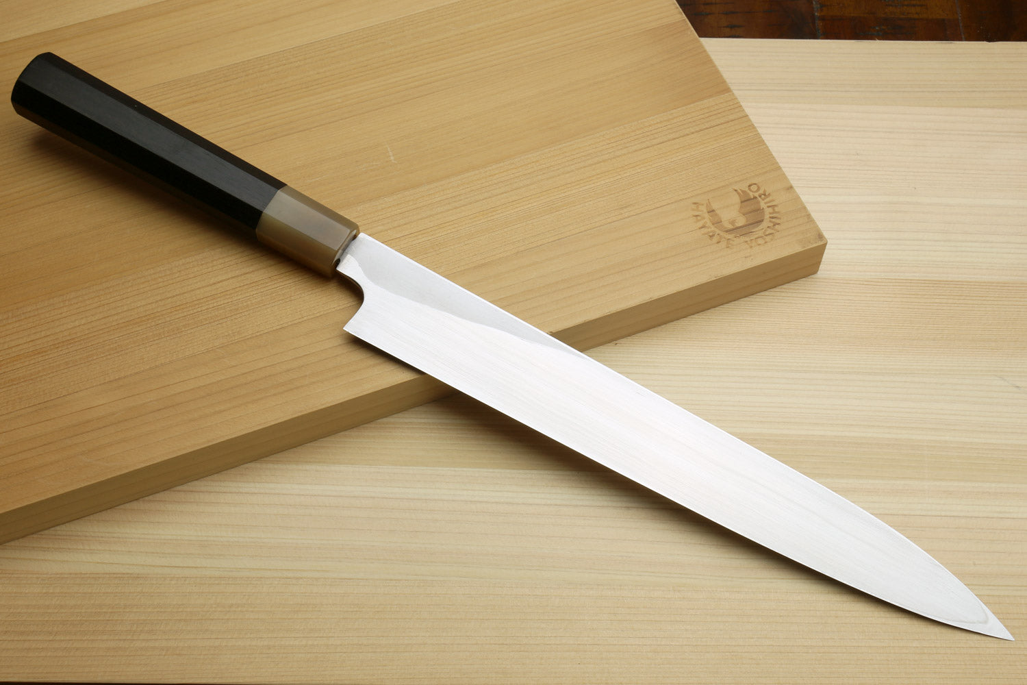 White steel yanagiba sushi knife with ebony handle and curved tip