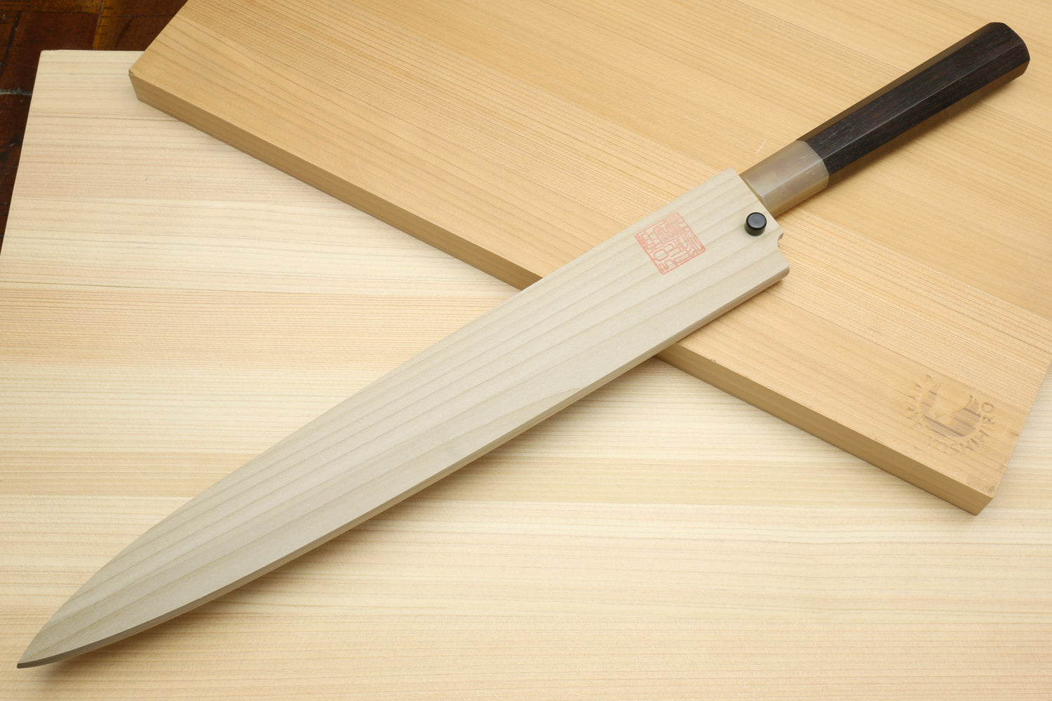 White steel yanagiba sushi knife with ebony handle, angled full view