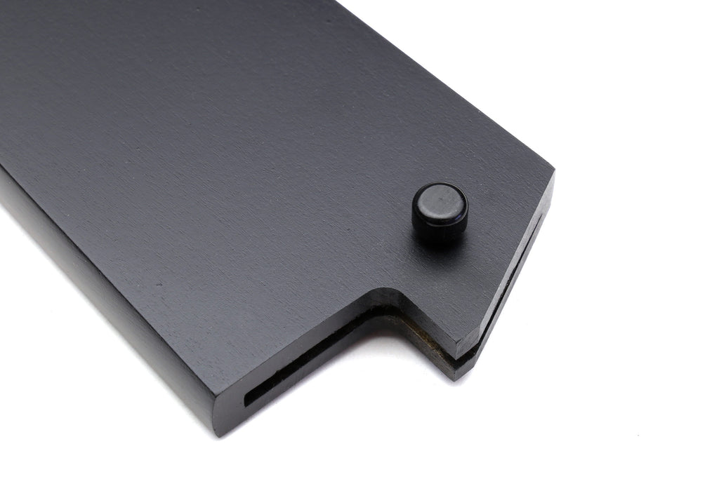 Black safety pin on dark saya cover plate