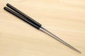 Ebony-handled plating tweezers with stainless tips, laid diagonally on wood surface