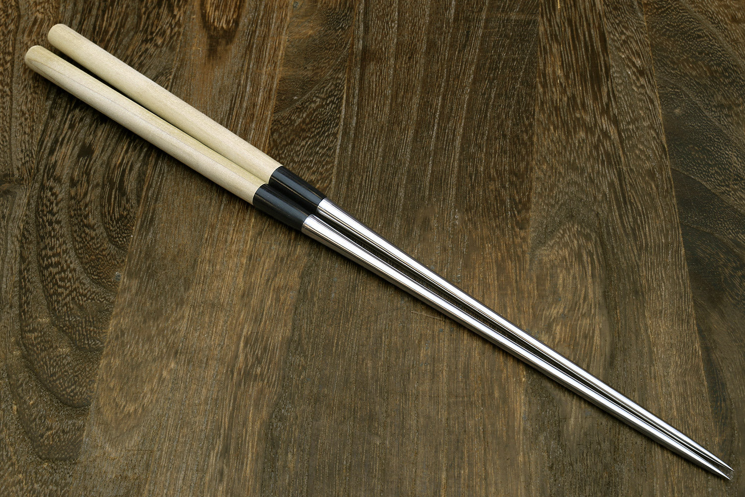Sushi tweezers pair with light wood handles and stainless steel tips
