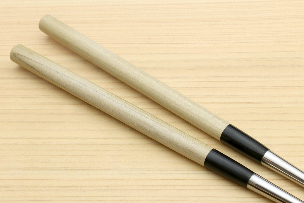 Sushi tweezers with two light wood handles and black collar, stainless tips
