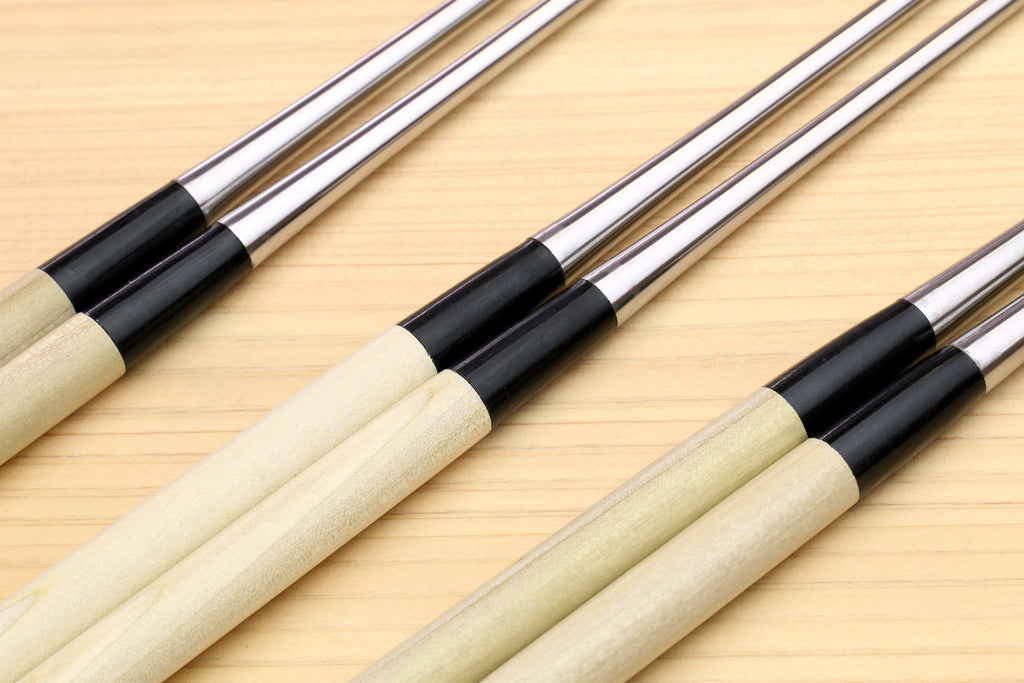 Set of sushi tweezers with light wood handles, black collars, and stainless points