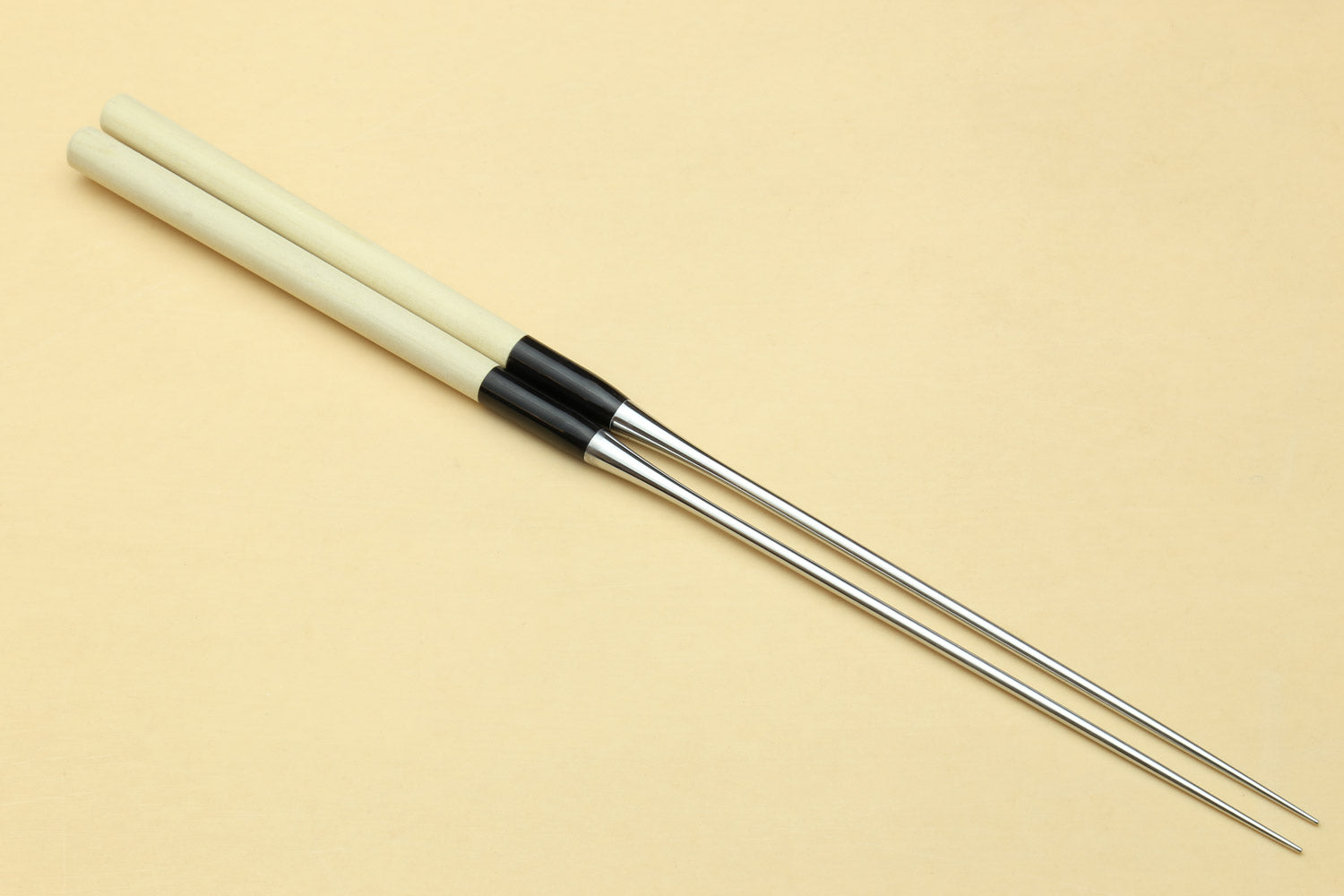 Single sushi plating tweezers with light wooden handle, black band, stainless tips