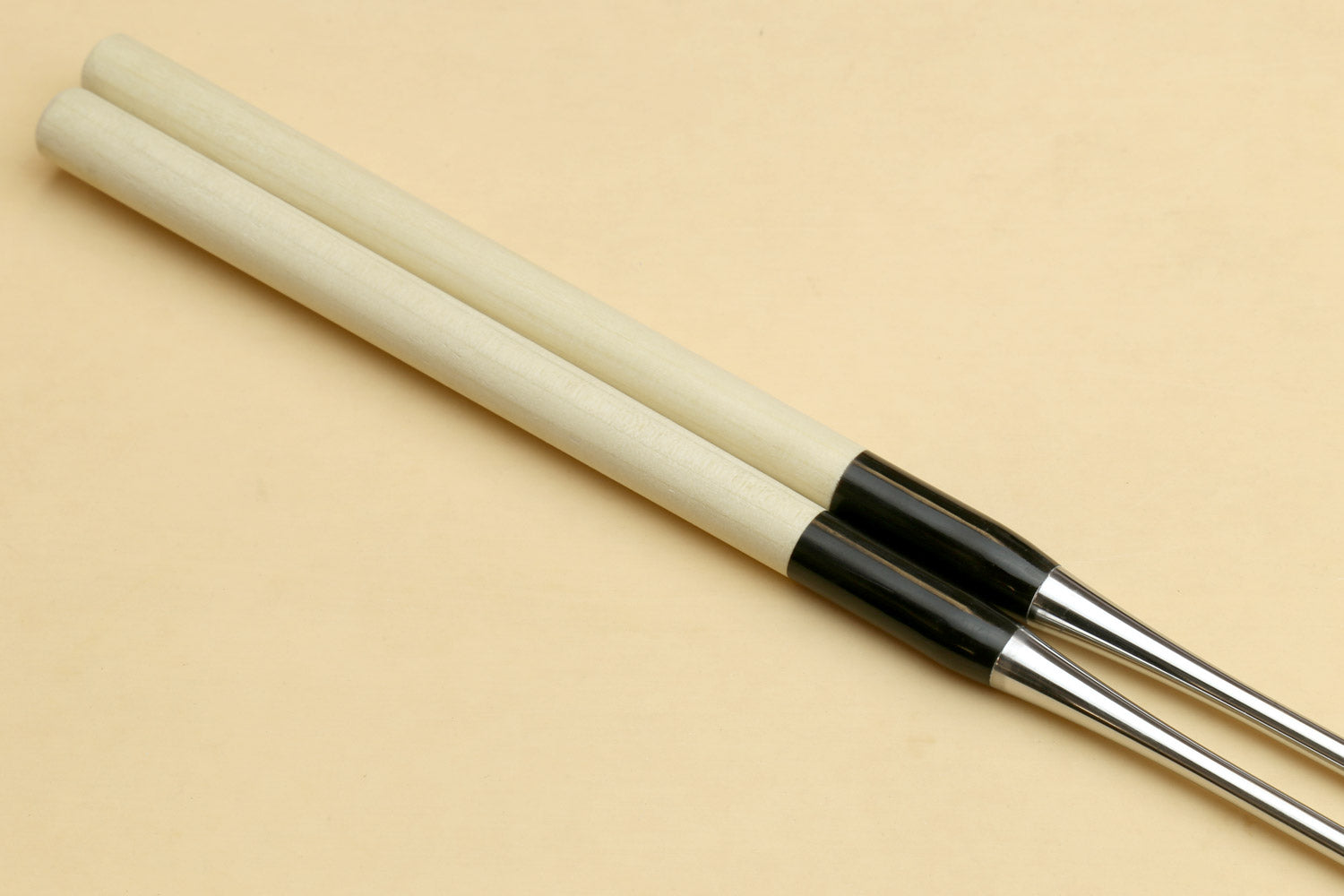 Sushi plating tweezers with light wooden handle and black collar, stainless tips