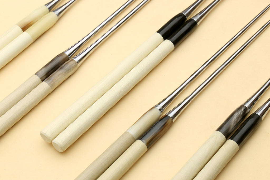 Set of sushi plating tweezers with light wooden handles and stainless pointed ends