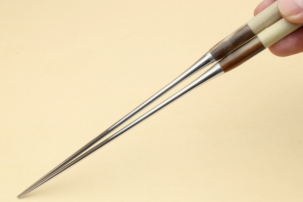 Sushi plating tweezers held in hand, light handle with stainless pointed tips
