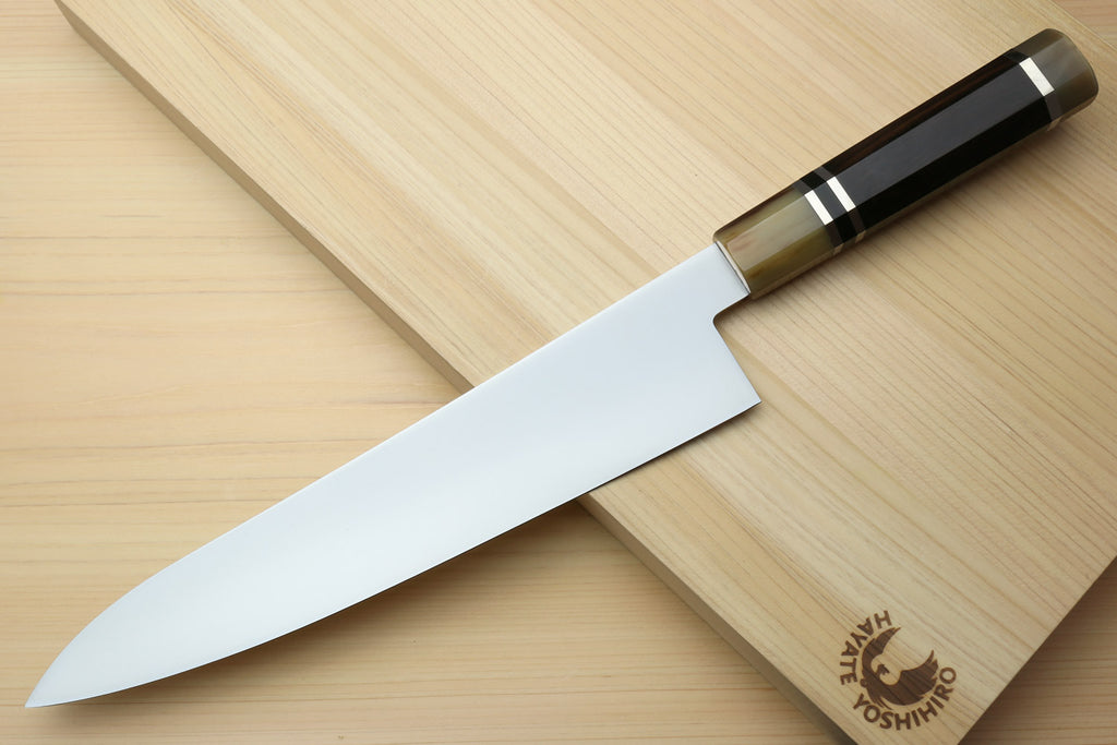 Japanese chef knife with stainless gyuto blade and dark octagonal handle, triple-ring