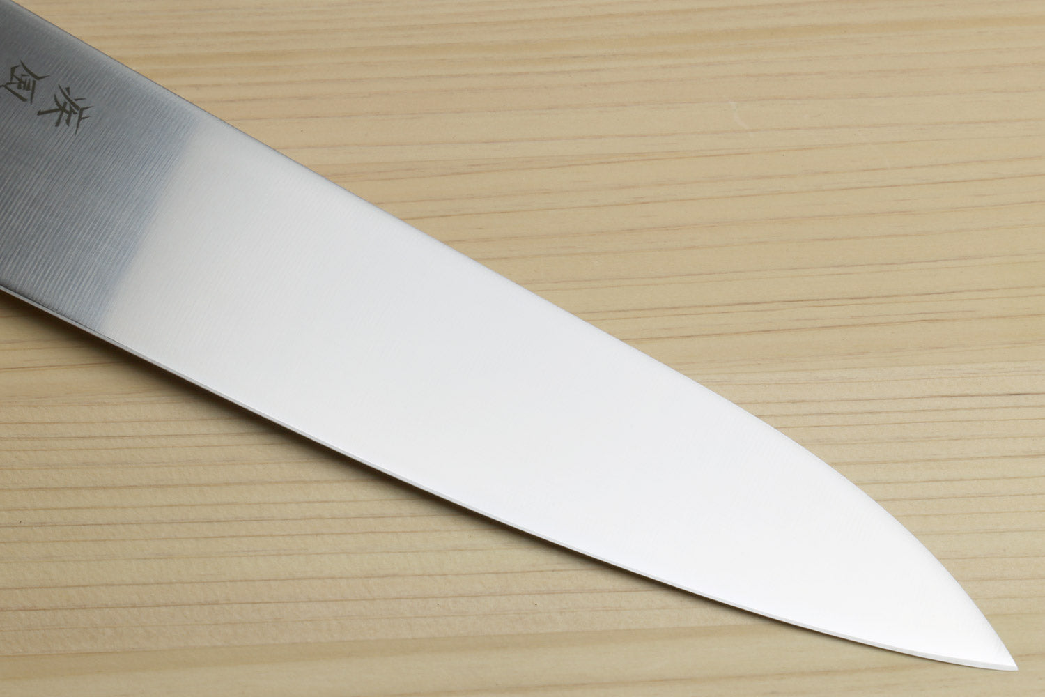Japanese chef knife blade close-up, satin finish with pointed tip