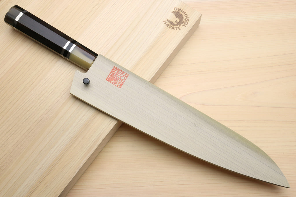 Japanese chef knife with stainless blade and dark octagonal handle with ring accents