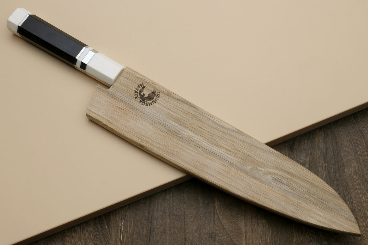 Japanese gyuto knife profile with ebony handle, ivory bolster, and wooden saya