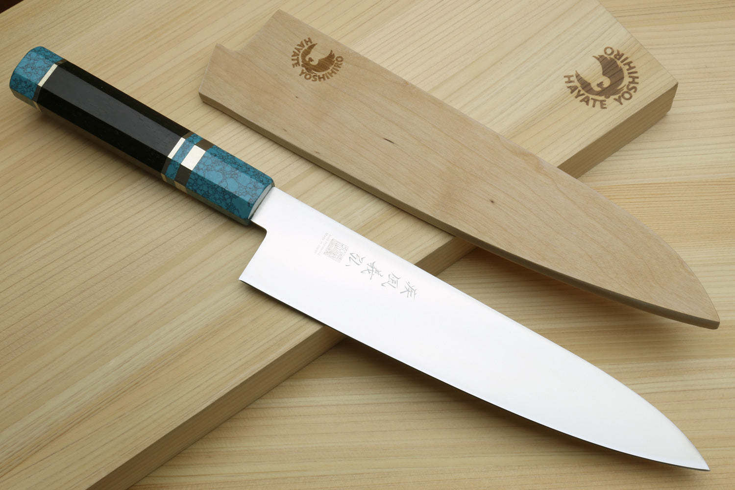 Stainless steel gyuto chef knife with turquoise blue handle and blade markings