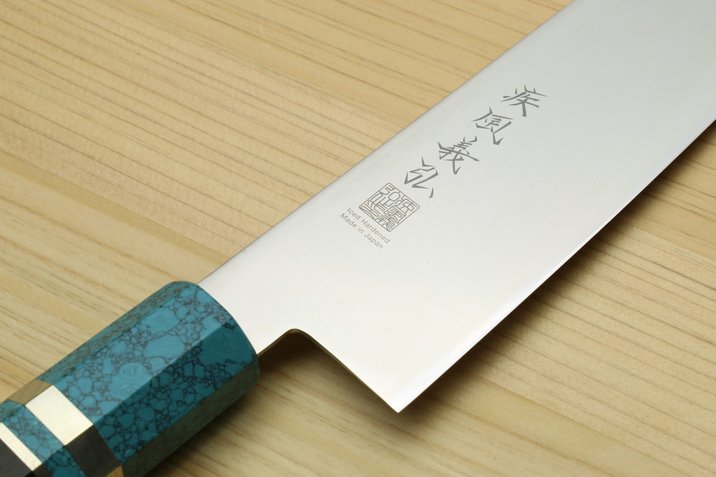 Stainless steel gyuto chef knife blade with etched characters, turquoise blue handle