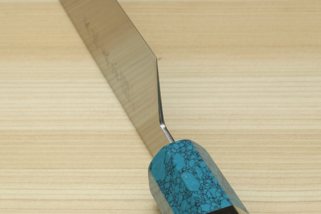 Stainless steel gyuto chef knife showing spine and turquoise blue handle