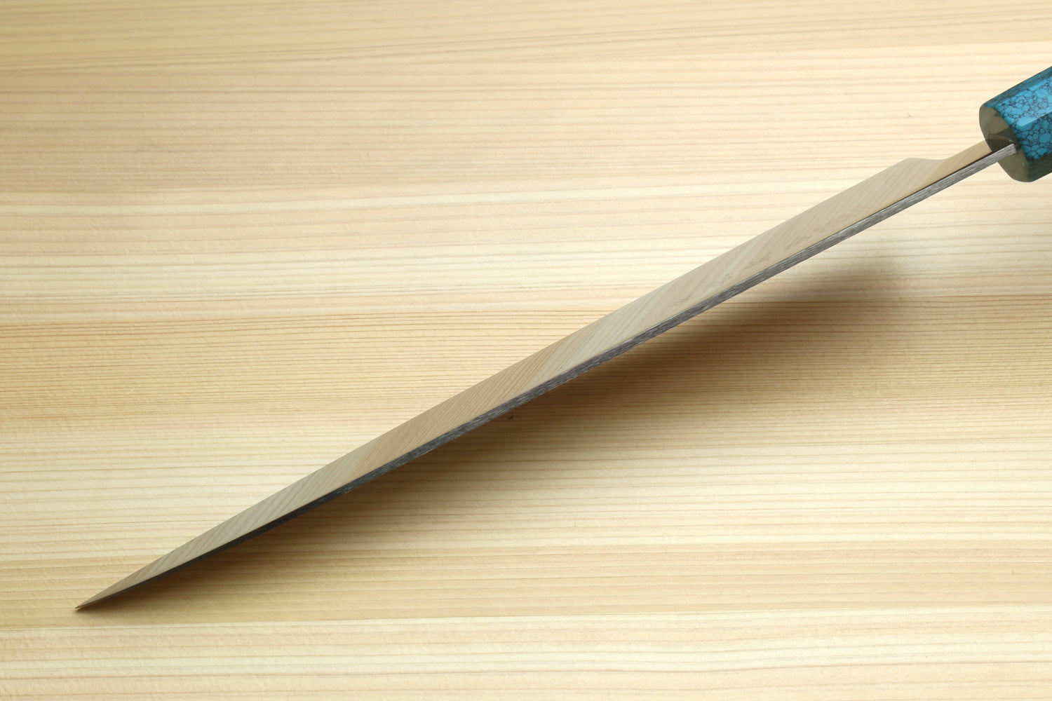 Stainless steel gyuto chef knife with pointed tip and turquoise blue handle