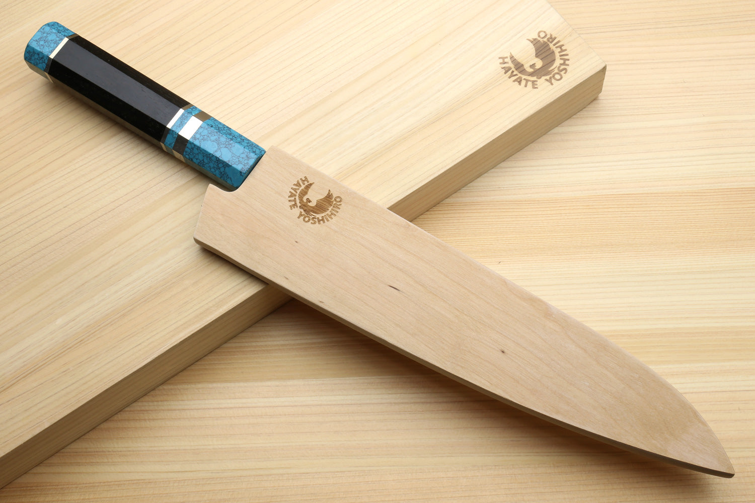 Stainless steel gyuto chef knife with turquoise blue handle and wooden sheath