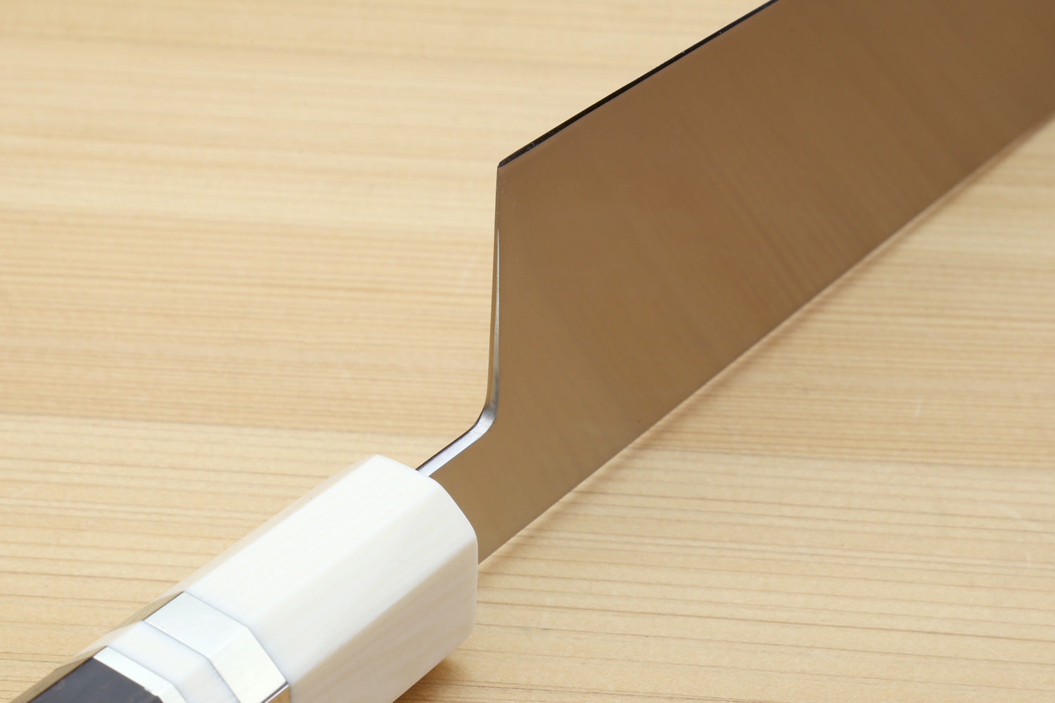Kiritsuke chef knife with stainless blade, ivory bolster, and ebony wood handle.