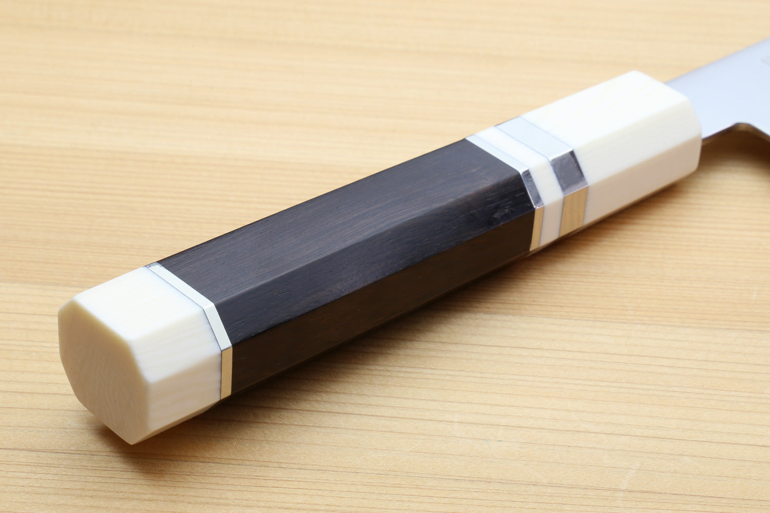 Kiritsuke chef knife handle with ebony wood and ivory bolster accents.